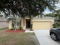 Charming one-story home with stone accents, a well-maintained yard, and a two-car garage at 4792 Summerfield Cir, Winter Haven, FL 33881