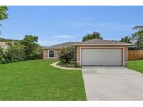 Charming single-story home features a well-manicured lawn and a two-car garage at 4836 Pierce Arrow Dr, Apopka, FL 32712