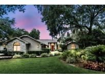 Charming single-story home with brick accents, mature trees and lush landscaping at 518 Stephanie Ct, Lake Mary, FL 32746