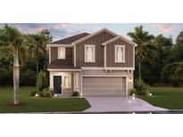 Charming two-story home featuring neutral siding, manicured landscaping, and an attached two-car garage at 669 Reggie Rd, Winter Haven, FL 33884