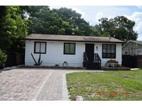 Charming single-story home with brick driveway, a cozy front yard, and a simple yet inviting facade at 233 N Hudson St, Orlando, FL 32835