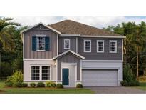 Charming two-story home with gray siding, blue shutters, and a well-manicured lawn at 2907 Haze Rd, Clermont, FL 34714