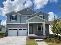Charming two-story home with a two-car garage and inviting front porch at 335 Ridgemark Ave, Groveland, FL 34736