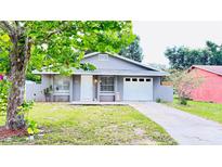 Charming single-story home with a well-maintained lawn and driveway, attached one car garage at 3362 Janet St, Apopka, FL 32712