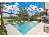 Gorgeous screened-in pool and lanai featuring a beautiful view of the pond at 11834 Gennaro Ln, Orlando, FL 32827