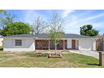 Charming single-story home featuring a brick facade, white trim, and a well-manicured lawn at 1432 Findlay St, Deltona, FL 32725