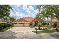 Charming single-story home features a brick driveway, tile roof and a manicured front lawn at 1528 Langham Ter, Lake Mary, FL 32746