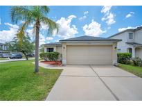 Charming home featuring a two-car garage, manicured lawn, and a beautiful palm tree at 1531 Tiverton Blvd, Winter Garden, FL 34787