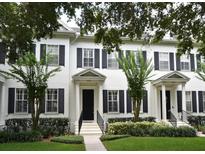 Attractive townhome exterior featuring lush landscaping and black shutters at 1649 Lake Baldwin Ln, Orlando, FL 32814