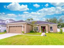 Charming single-story home with well-manicured lawn and beautiful landscaping at 2031 Gloria Oak Ct, Orlando, FL 32820