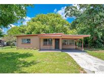 Charming single-story home featuring a covered carport, fresh exterior paint, and a well-manicured lawn at 102 Mayrose Dr, Sanford, FL 32771