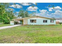 Charming vintage home featuring a well-manicured lawn, carport, and quaint curb appeal at 1210 S Palmetto Ave, Sanford, FL 32771