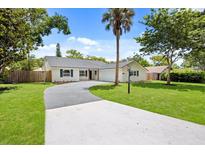 Charming single story home with a winding driveway, lawn, mature trees, and updated paint at 2089 Sunderland Rd, Maitland, FL 32751