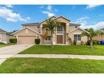 Spacious two-story home with manicured lawn and a two-car garage at 2871 Paige Dr, Kissimmee, FL 34741