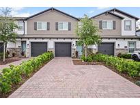 Beautiful townhomes featuring brick driveways, attached garages and manicured landscaping at 463 Cape Honeysuckle Pl, Sanford, FL 32771