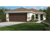 Charming one-story home featuring a two-car garage and a well-manicured lawn at 121 Acer Ln, Auburndale, FL 33823