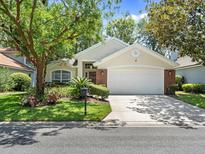 Charming home with lush landscaping, a two-car garage, and a well-maintained lawn at 1427 Whitehall Blvd, Winter Springs, FL 32708