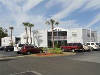 Cozy two-story condo building with beautiful palm trees and parking at 3863 Atrium Dr # L-6, Orlando, FL 32822