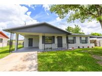Inviting single-story home featuring a covered carport, a well-maintained lawn, and tasteful landscaping at 4469 Evers Pl, Orlando, FL 32811