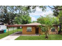 Charming single-story home with a covered carport and mature landscaping at 4757 Goldsboro Ct, Orlando, FL 32811