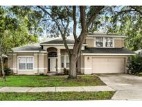 Charming two-story home with a well-manicured lawn and inviting front entrance at 3110 Heartleaf Pl, Winter Park, FL 32792