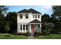 Charming two-story home featuring a classic design, complemented by a well-manicured lawn and landscaped garden at 490 Winsome Aly, Groveland, FL 34736