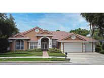 Charming single-story home featuring a three-car garage and well-manicured front lawn and double door entrance at 643 Cricklewood Ter, Lake Mary, FL 32746