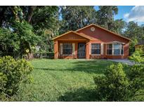 Charming one-story home featuring a well-maintained lawn and mature trees at 1603 15Th, Sanford, FL 32771