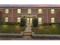 Charming brick building with well-maintained landscaping, green shutters and inviting entryway at 202 Georgetown Dr # C, Casselberry, FL 32707