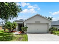 Charming single-story home features a well-maintained lawn and inviting curb appeal at 5671 Sycamore Canyon Dr, Kissimmee, FL 34758