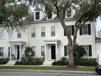 Charming two-story townhome with black shutters, dormer windows and welcoming front entrance at 1126 Celebration Ave, Celebration, FL 34747