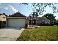 Charming single-story home features an attached two-car garage and well-maintained front lawn at 1128 Lyric Dr, Deltona, FL 32738