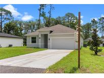 Charming single-story home with a well-maintained lawn and attached two-car garage at 1765 9Th Ave, Deland, FL 32724