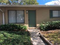 Charming front entrance with a teal door, well-maintained landscaping, and visible house number at 220 Cherokee Ct # 116, Altamonte Springs, FL 32701