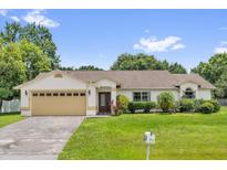 Charming single-story home features a well-manicured lawn, neutral paint, and a convenient two-car garage at 3750 Oak Pointe Blvd, Kissimmee, FL 34746