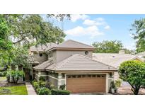 Charming home with a well-manicured lawn, a two-car garage, and beautiful landscaping at 4251 Willow Bay Dr, Winter Garden, FL 34787