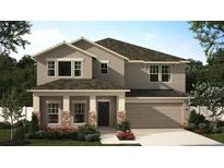 New construction two-story home featuring a two car garage and a covered front entryway at 451 Lemongrass Rd, Minneola, FL 34715