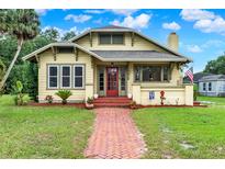 Charming single-Gathering home with a red brick walkway and a cozy front porch with eye-catching red door at 1013 W 20Th St, Sanford, FL 32771