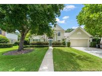 Charming home featuring a beautifully landscaped front yard and inviting curb appeal under a sunny sky at 1362 Hampstead Ter, Oviedo, FL 32765