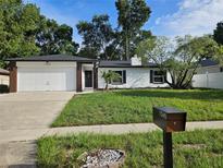Charming single-story home with a well-manicured lawn and a two-car garage at 1546 Providence Cir, Orlando, FL 32818