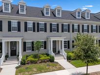 Charming townhome featuring a well-manicured lawn and inviting entrance at 1859 Island Village Way, Kissimmee, FL 34747