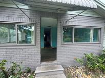 Charming front entrance to this brick home featuring a covered entryway and newer windows at 269 12Th Ave, Ocoee, FL 34761