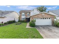 Charming two-story home with brick accents, attached garage, and a well-maintained lawn at 3310 Tall Timber Dr, Orlando, FL 32812
