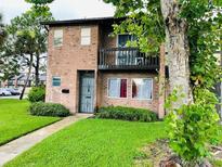 Charming two-story brick home with a balcony and well-maintained front lawn at 5084 Downing St # 2, Orlando, FL 32839