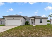Charming one-story home featuring a two-car garage and well-manicured lawn at 109 Violet Ct, Kissimmee, FL 34759