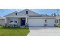 Charming single-story home with a two-car garage, covered porch, and nicely landscaped front yard at 1985 Walnut Creek Dr, Kissimmee, FL 34744