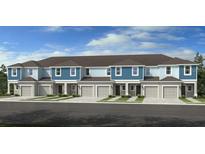 Charming townhome features a gray garage and a blue accent, creating an inviting curb appeal at 2580 Penguin Blvd, Davenport, FL 33837