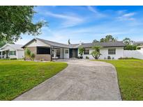 Charming single-story home with a curved driveway and well-manicured lawn at 2844 Scarlet Rd, Winter Park, FL 32792