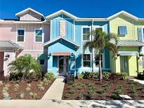 Colorful townhomes featuring manicured landscaping and charming pastel exteriors on a sunny day at 3117 Caribbean Soul Dr, Kissimmee, FL 34747