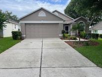 Charming single-story home with a well-maintained front yard and a spacious two-car garage at 4012 Capland Ave, Clermont, FL 34711